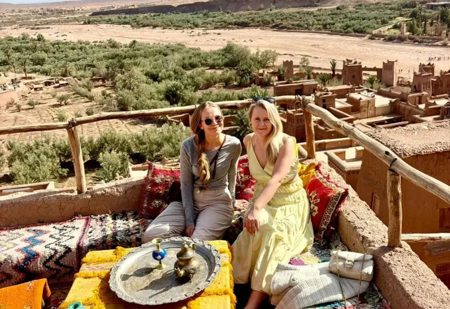 Camel Ride Trips travelers on a rooftop terrace above Ait Ben Haddou near Ouarzazate
