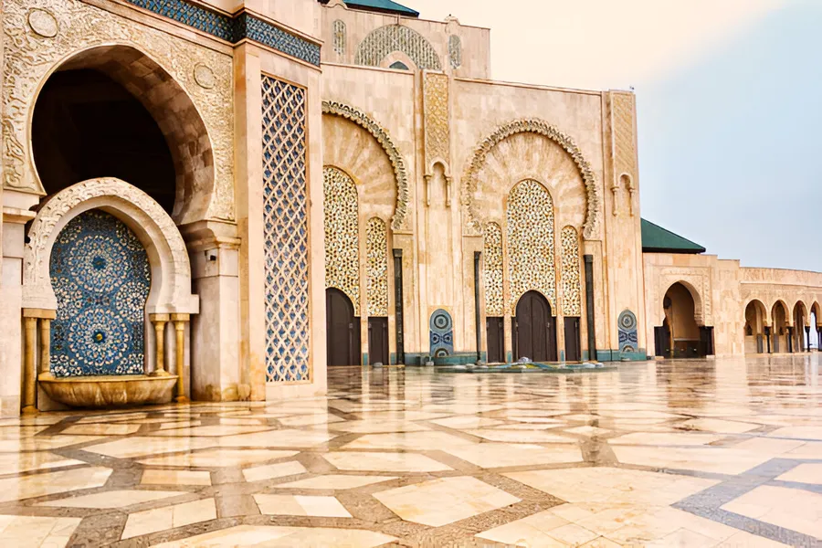 Zellige fountain and carved arches on the facade of the Hassan II Mosque, Casablanca, day 1 of the 14-Day Morocco Tour from Casablanca: Morocco at Leisure