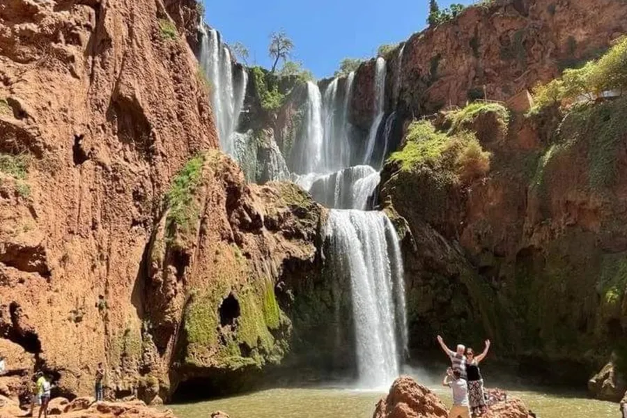 Travelers on the rocks by the pool below the Ouzoud waterfalls, day 4 of the Ouzoud Waterfalls Day Trip from Marrakech